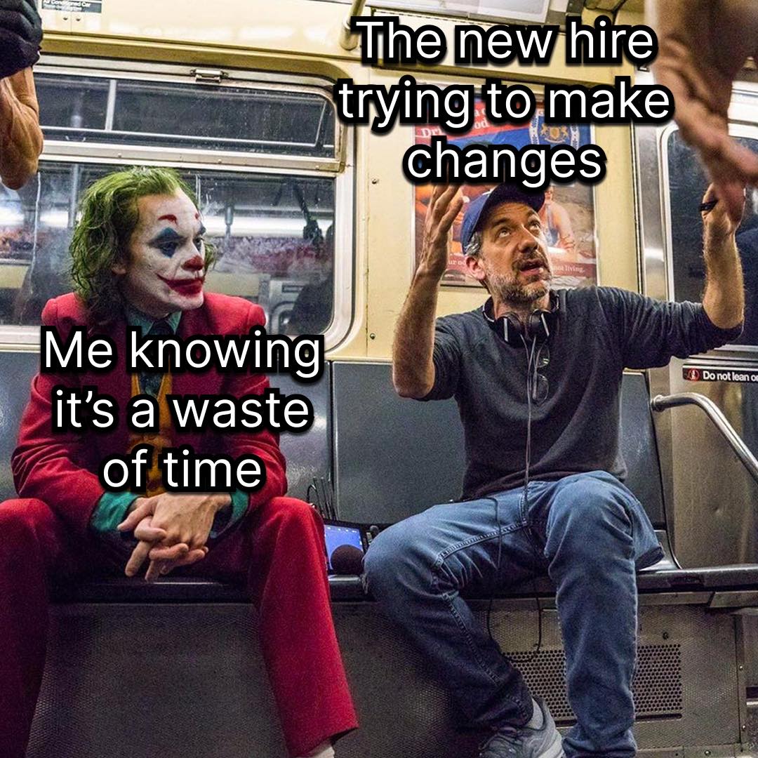 This meme features a photo of two characters from the movie "Joker" (2019) sitting on a train. The Joker (played by Joaquin Phoenix) is sitting next to a director (played by Robert De Niro) who is explaining something to him. The text on the meme reads: "The new hire: 'I have no idea what I'm doing.' Director: 'It's okay, it's a learning experience.'"